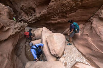 people climbing on rocks in Utah