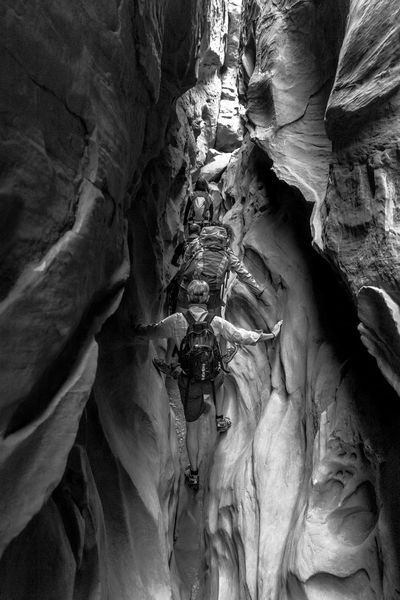 people climbing in a cave